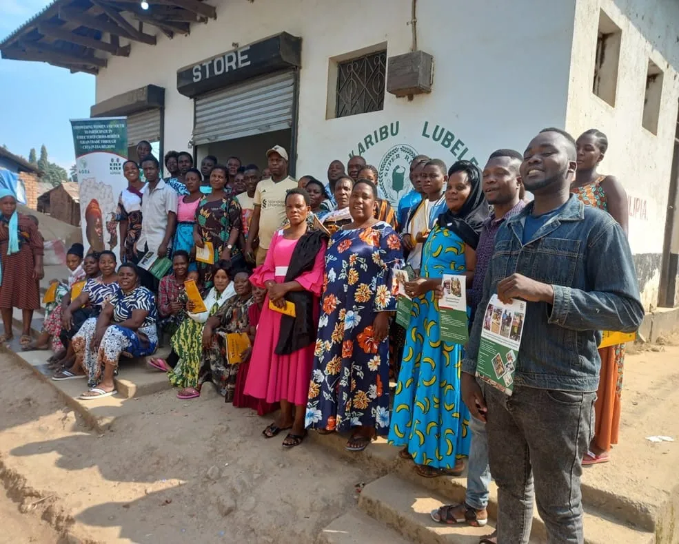 Group photo of traders at the Kasumulu CBTA formation event outside a village store