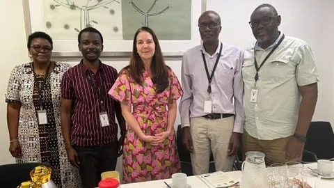 AGMARK team members with a partner representative at an office meeting for the South Sudan climate-resilience project