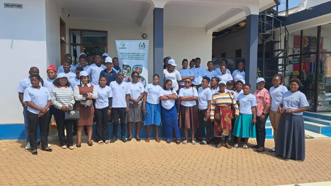 Group of CBTA trainees in matching white t-shirts posing outside a training venue in Tunduma