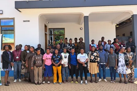Group photo of trade training participants outside a reception building in Tunduma