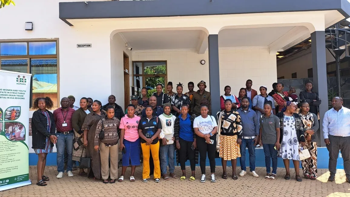 Group photo of trade training participants outside a reception building in Tunduma