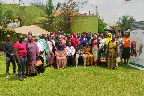 Group photo of women cross-border grain traders at a training event in Busia, Uganda