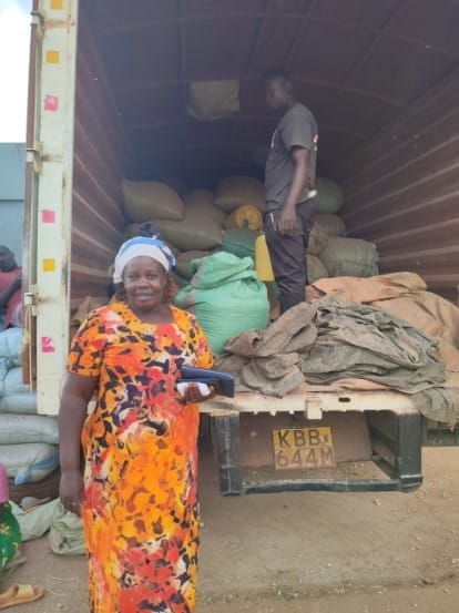 Ms. Pauline Ikapoloni supervising loading of grains onto a trailer