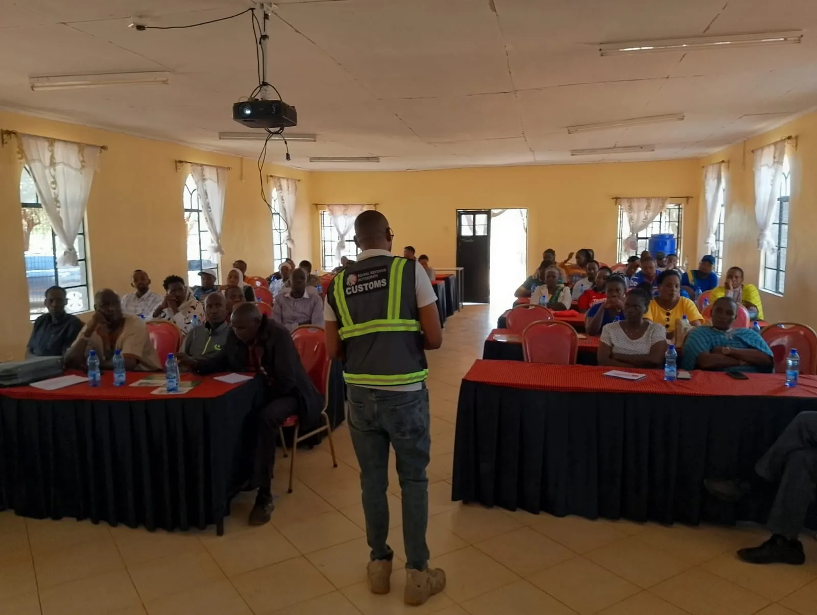 Kenya Bureau of Standards representative presenting on the significance of grain trade at the Namanga training