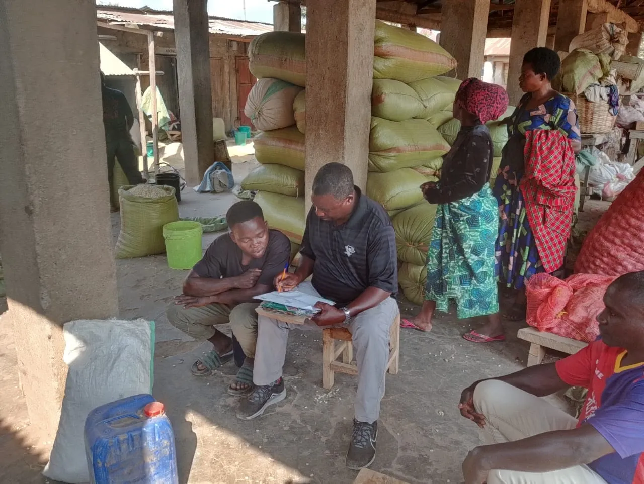 Youth traders at a grain aggregation center being mobilized for the Kasumulu CBTA formation